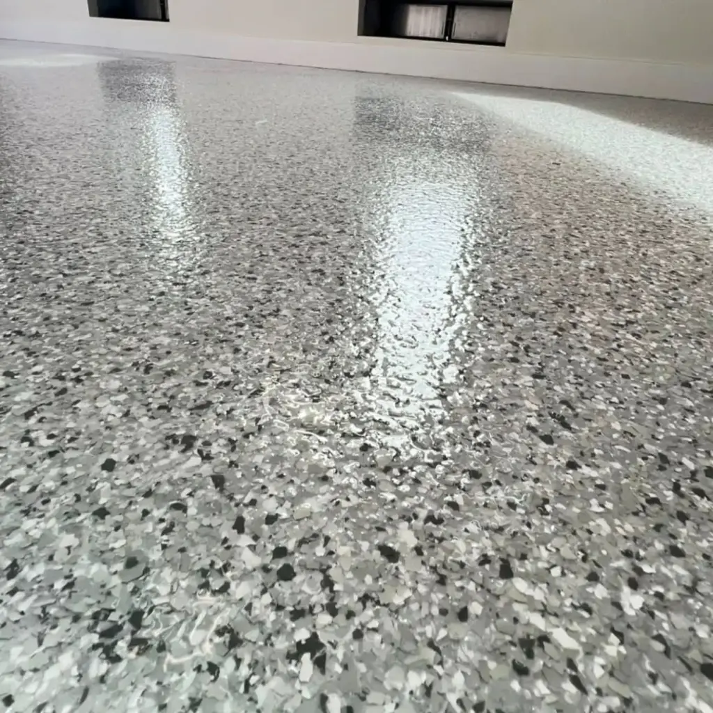 Shiny gray epoxy floor with speckles in a bright room