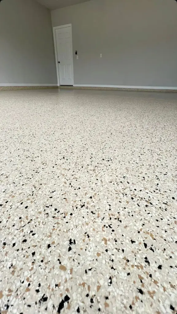 Close-up of a light-colored epoxy floor with speckles